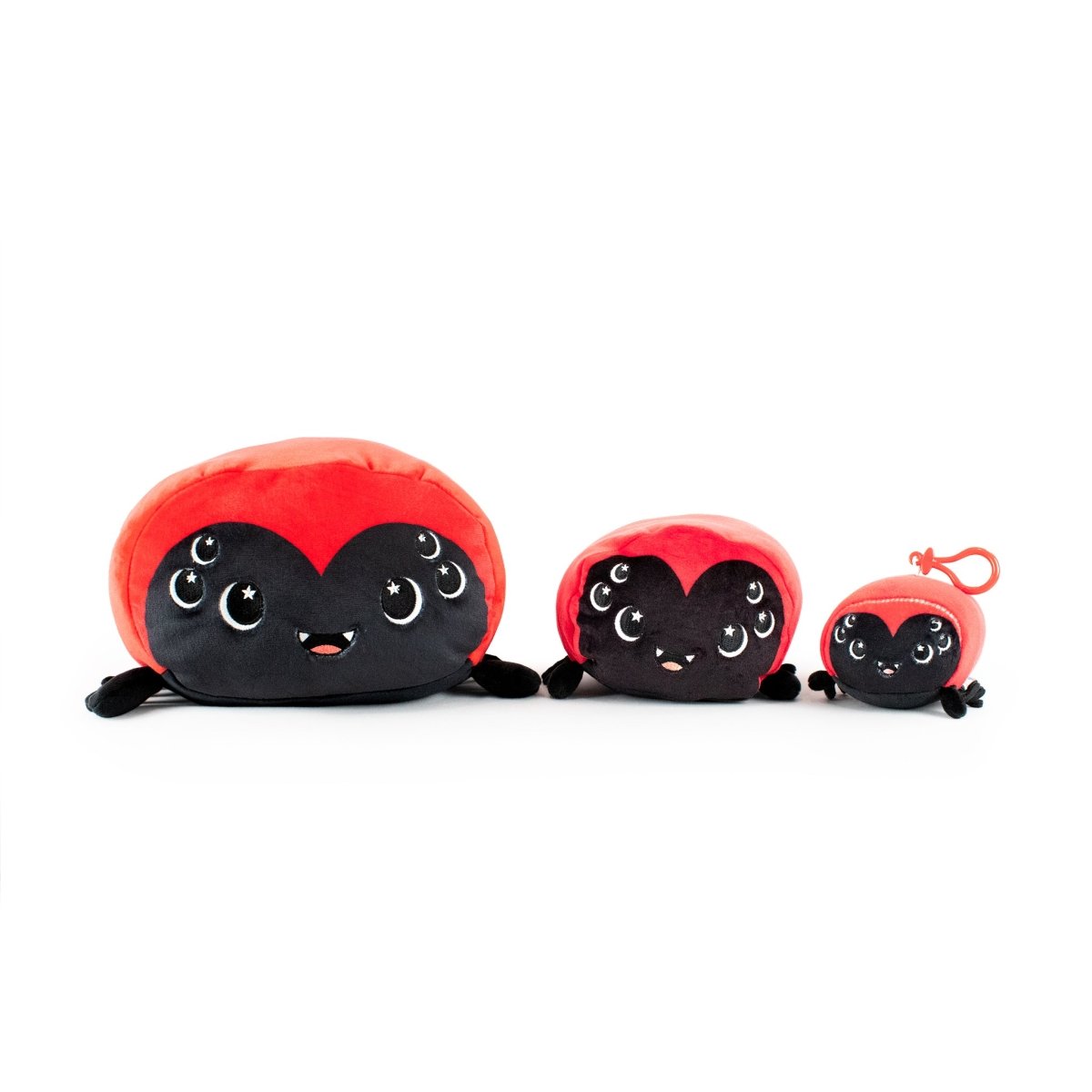 Three Muffet the Spider Plushies in small, medium, and large sizes sit together. Each features a black body, cute smiling face, sparkling eyes, and soft legs—perfect to pair with your Moosh-Moosh pillow or Halloween plushie!.