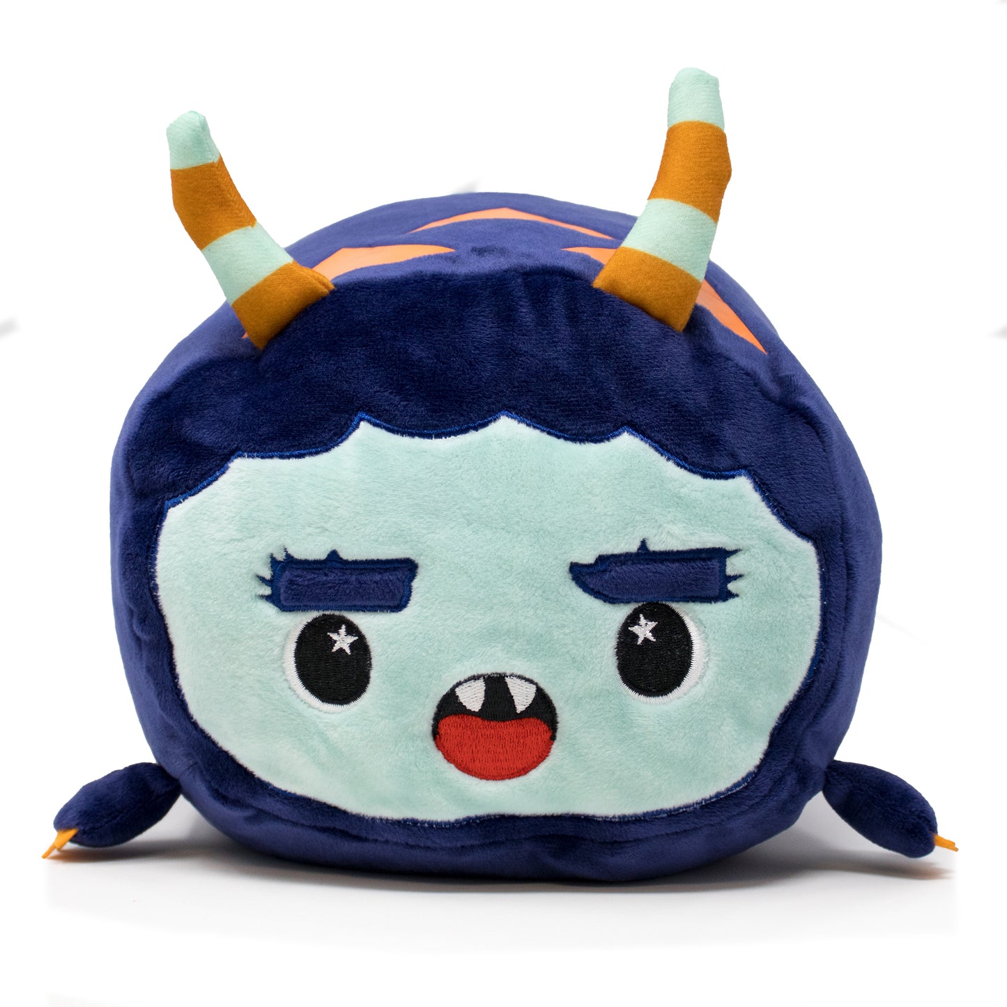 Spike the Monster Plushie is a cuddly, round plush with a blue and turquoise face, big smile revealing two teeth, and starry eyes. Its softness is heightened by orange and turquoise striped horns and small braided side details.
