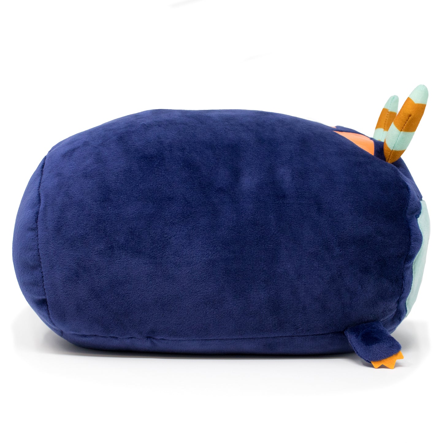 Introducing Spike the Monster Plushie: a soft, sensory delight shaped like a blue oval with small colorful wings and a tail, offering cuddly comfort on any flat surface.