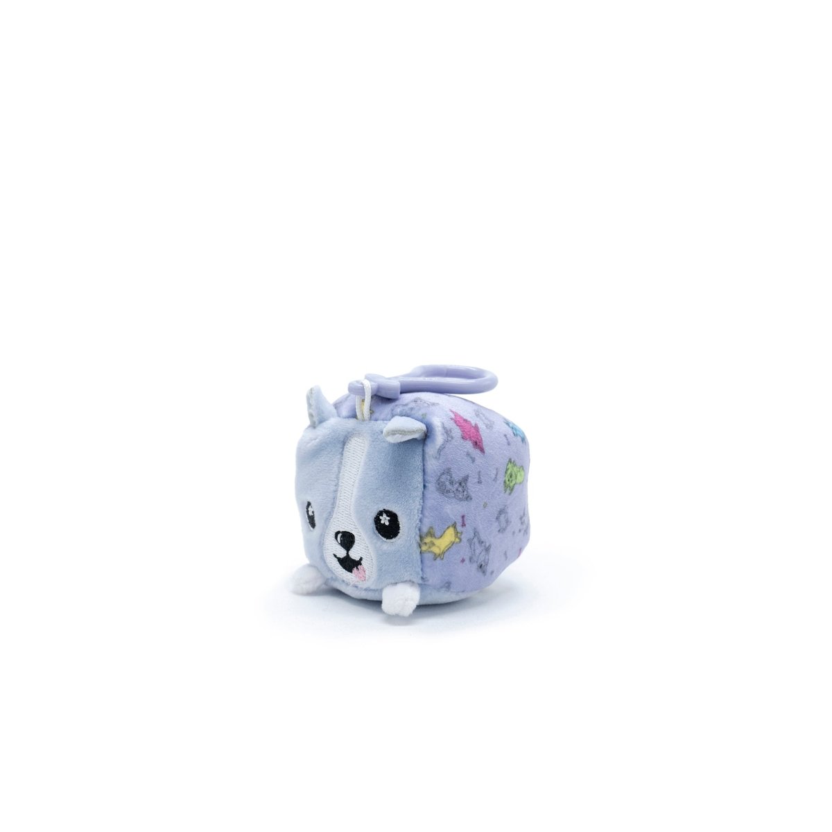 The charming Connie the Corgi Square Plush Clip-On is a gray and white cube-shaped toy with ears, a tail, and an adorable face. As part of the Moosh-Moosh Series 1 Squared collection, it features colorful side patterns.