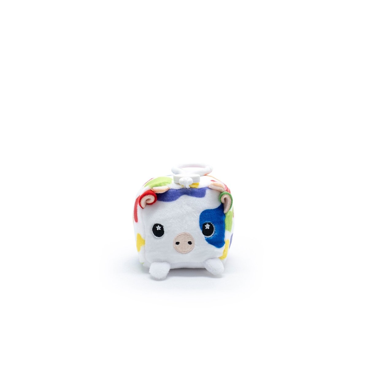 Milly the Cow Square Plush Clip-On, a cube-shaped stuffed animal from Moosh-Moosh Series 1, features colorful patches and a charming face with big eyes and a small snout against a plain white background.