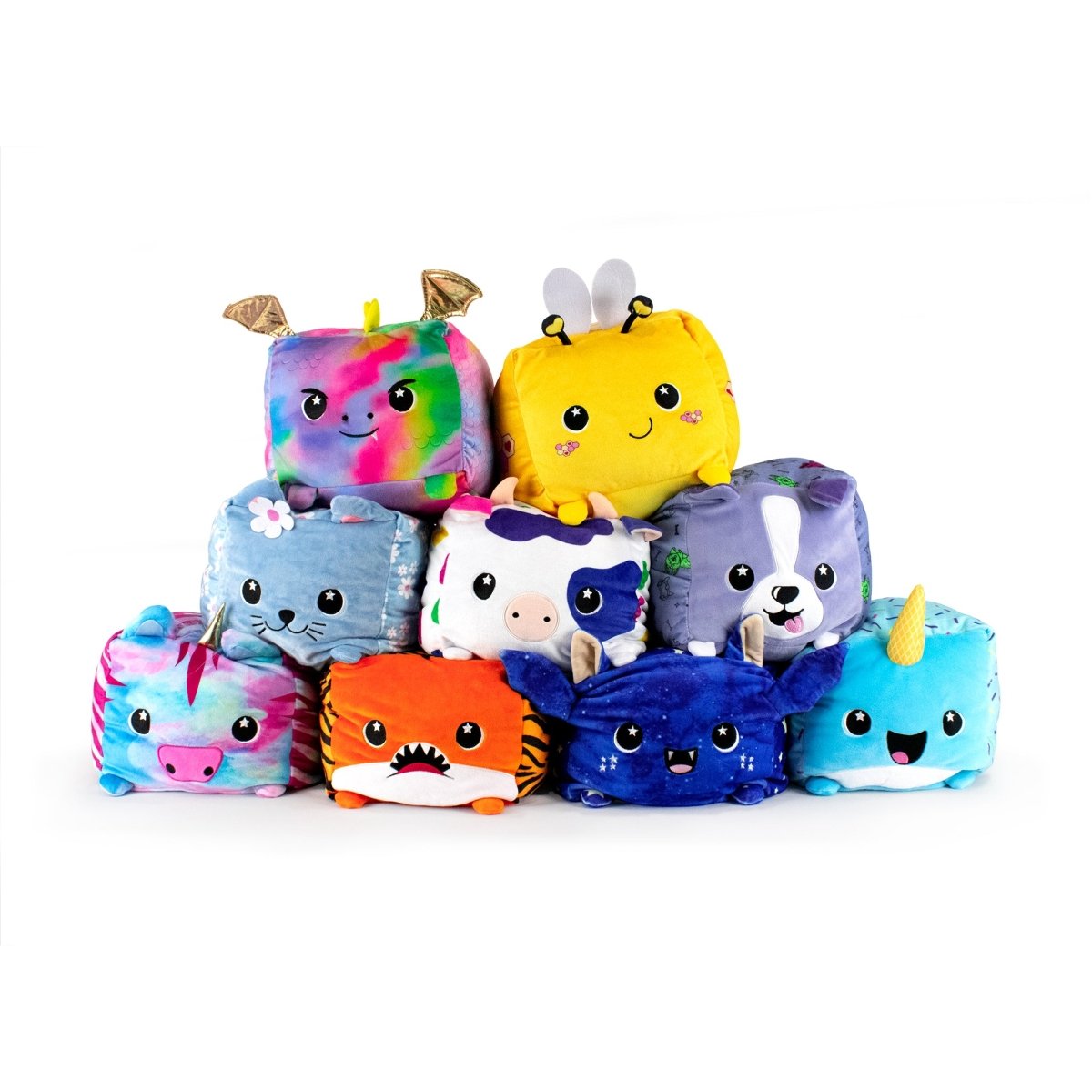 A pyramid of Moosh-Moosh SQUARED² plushies presents charming animal designs like rainbow-colored bears and Milly the Cow, each showcasing adorable faces and vibrant patterns with unique features such as ears, horns, and wings.