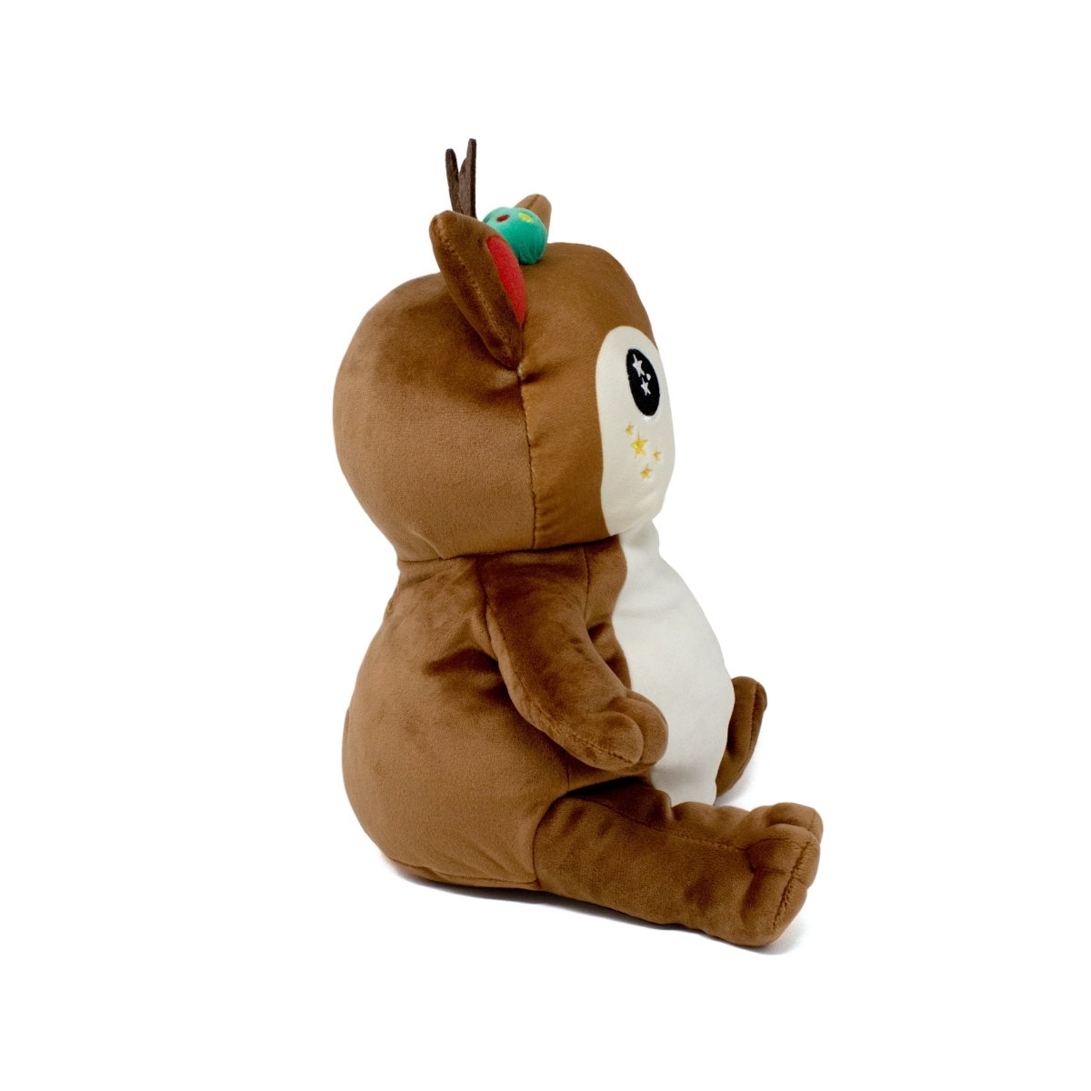 Mitzy the Reindeer Starlight Buddy is an adorable plush toy with soft brown fur, a white belly, tiny antlers, and a red-tipped ear. It sits upright with large round eyes featuring star designs beneath them and has a small green bird perched on its head.