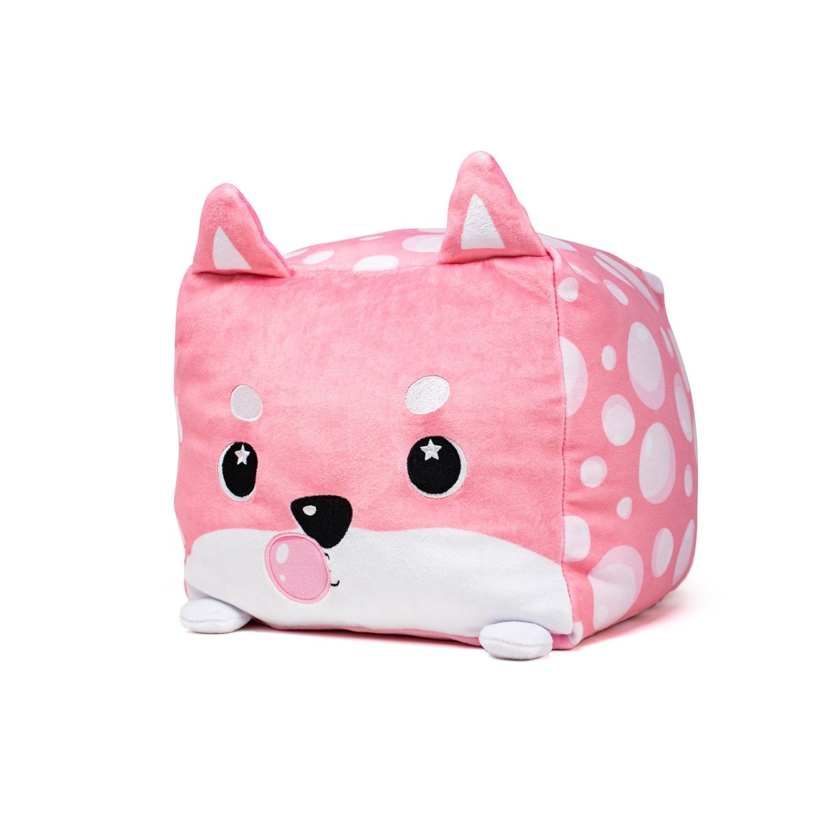 The Sweet Tooth Shiba Puppy Plushie is a pink, cube-shaped toy with a cute animal face, featuring starry black eyes. It has small ears, a white snout with polka dots, and tiny white feet—perfect for cuddling.