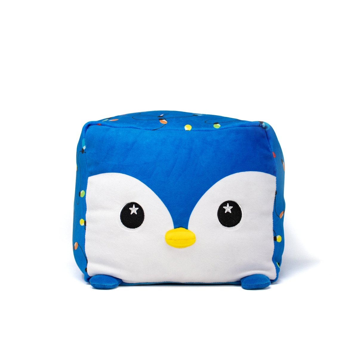 The Tanzy Plushie is a blue, cube-shaped Moosh-Moosh Squared2 penguin with big black eyes, a yellow beak, and small round feet—an adorable holiday plush toy shown on a plain white background.