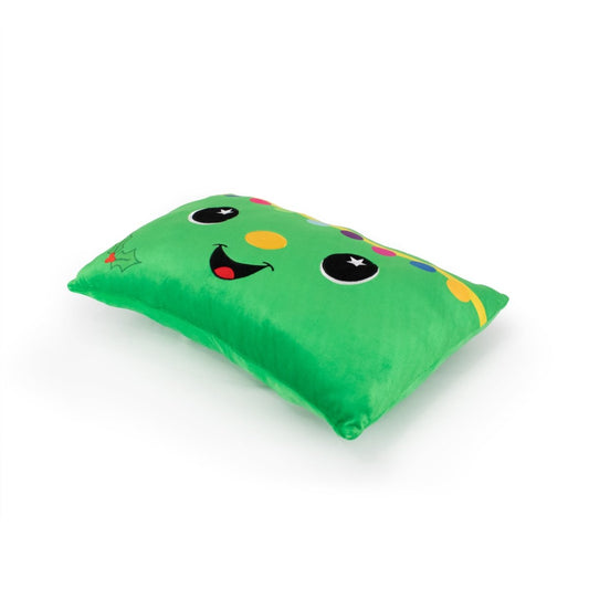 Treestan the Xmas Tree Pillow is a soft, green plush with a playful cartoon face, boasting big eyes, a wide smile, a yellow nose, and colorful confetti-like shapes on a plain white background.