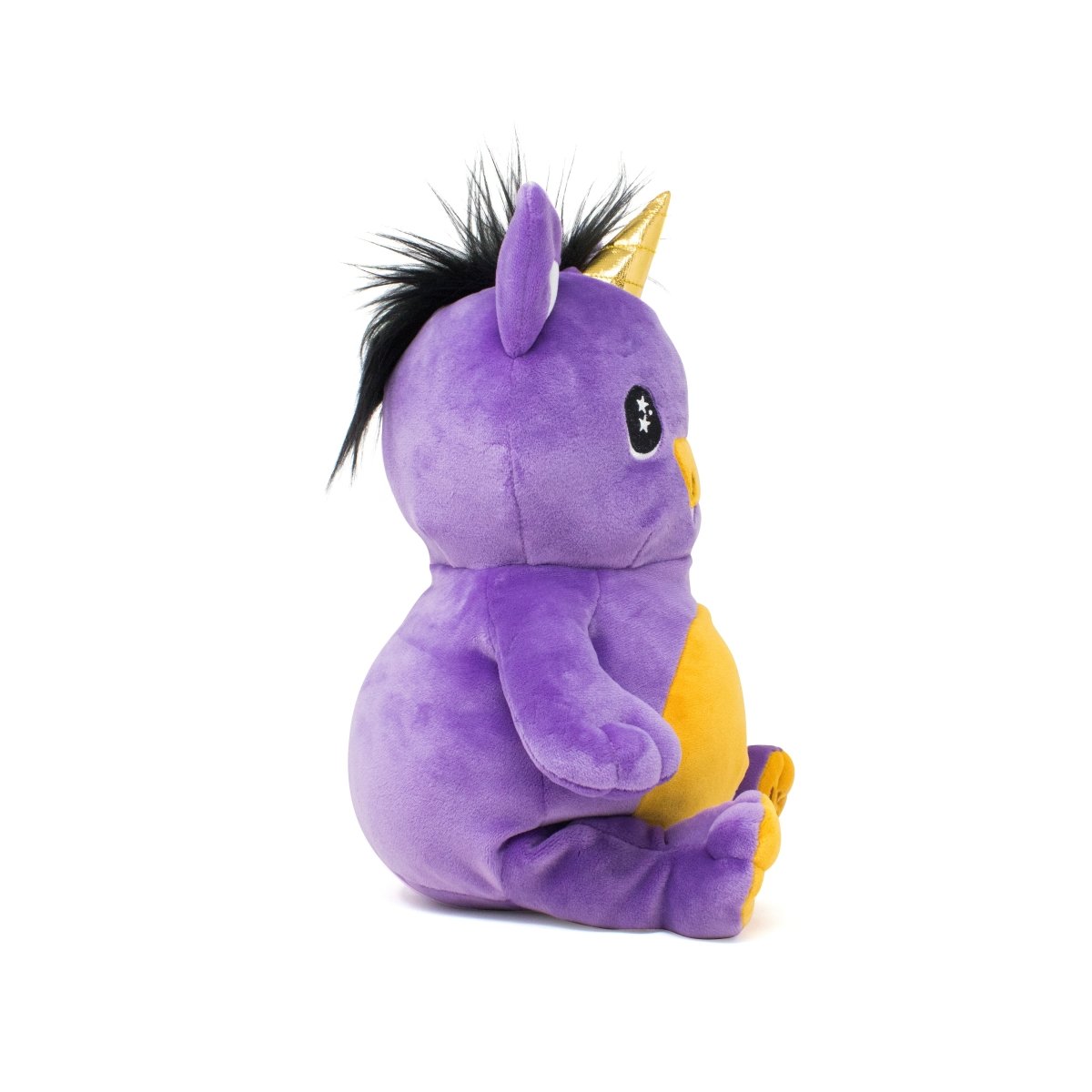 A side view of Amethyst the Unicorn Plushie Starlight Buddy, a purple unicorn with a yellow belly, orange feet, golden horn, black mane, and starry embroidered eyes from the Moosh-Moosh Spooky Series, sitting upright on a white background.