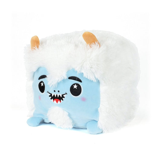 Yara the Yeti is a plush toy with white fluffy fur, blue body, orange horns, black eyebrows, starry eyes, rosy cheeks, and a friendly smile with tiny fangs—crafted for ultimate sensory softness.