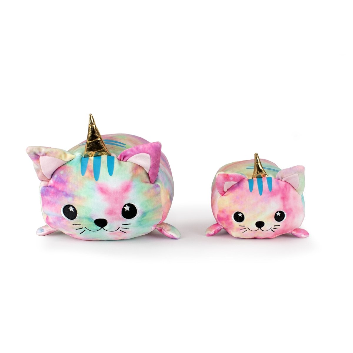 Two plushies of Madoka the Caticorn, shaped like cats with unicorn horns, feature pastel tie-dye colors, black eyes, pink ears, and small smiles. The larger one sits to the left of the smaller one.