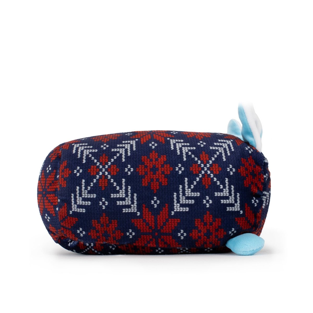 Yuki the Snowfox Slumber is a plush, cylinder-shaped toy with a blue and red knitted winter pattern, small blue feet, and two blue-and-white ears—perfect for cozy holiday nights.