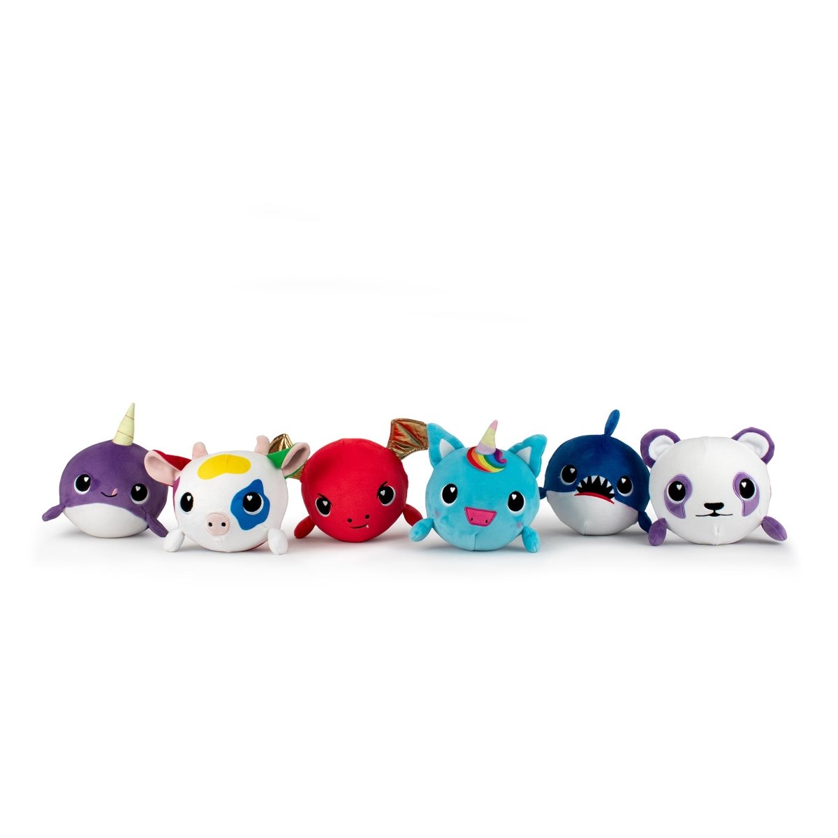 A row of six small, round "Jumbo Plushy Skwishy Sparkle" toys with cute faces: a purple narwhal, a unicorn, a red creature, a turquoise unicorn, a blue shark, and a white panda—each adorned with colorful accents.