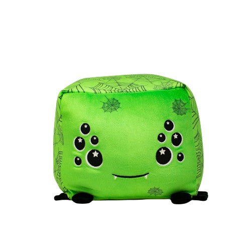 The green, cube-shaped plushie named Charlotte the Spider features a cute face adorned with large, star-patterned eyes. Tiny black feet and intricate web and spider designs add to its unique charm.