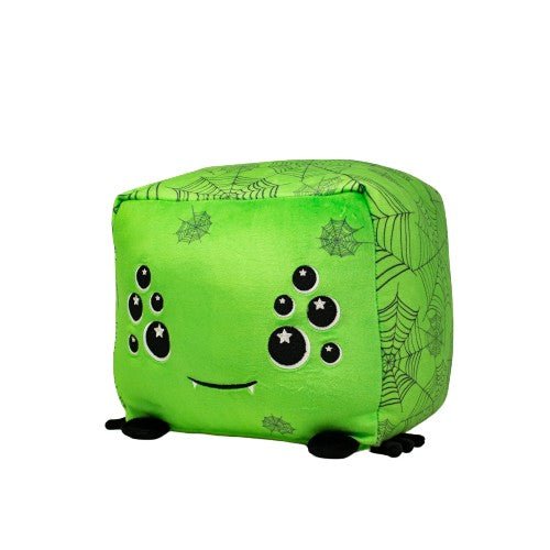 Charlotte the Spider is a green plush cube character with black spider webs and stars, smiling with small black legs and eyes. This cuddly stuffed animal is perfect for adding charm to any collection.