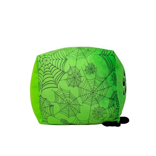 Charlotte the Spider is a soft, green, cube-shaped plushie with black spiderweb patterns, featuring a pair of black eyes on one corner and a small black tail at the bottom.