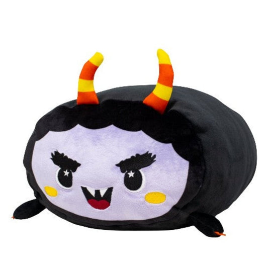 Fang the Monster Plushie features a round purple face, yellow and red striped horns, black hair, pointed fangs, dramatic eyebrows, blushing cheeks, and tiny black feet—part of the adorable Moosh-Moosh Spooky Series.