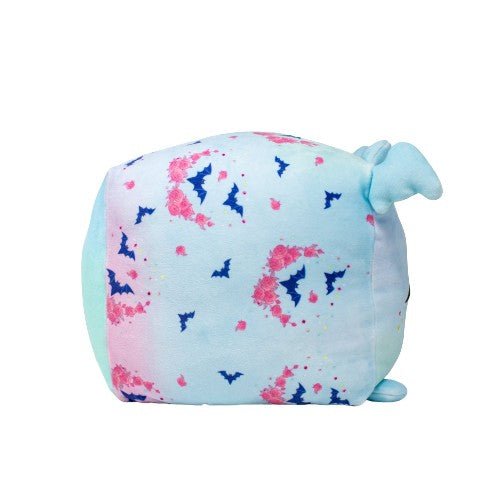 Hiso the Bat is a pastel blue and pink plushie cube with bat and rose patterns, small blue ears, and a tiny tail on one side.