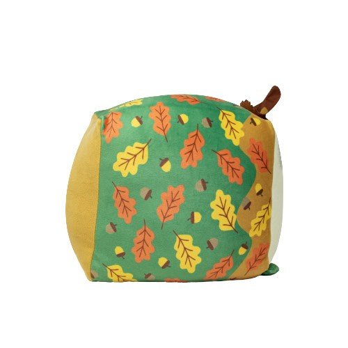 Tatters the Scarecrow is a square autumn plush pillow with a green leaf-acorn design on the front, tan sides, and a brown stem and green leaf on top—perfect as a soft, cuddly toy for cozy fall décor.