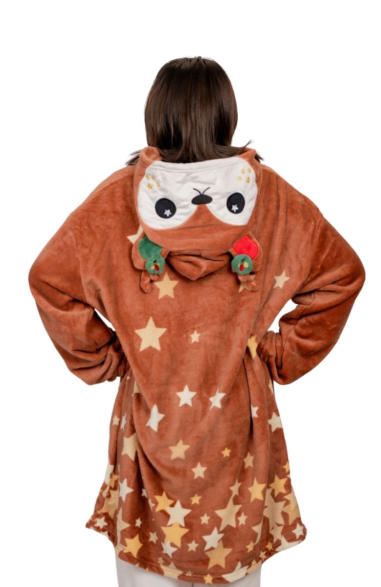 A person wearing the Mitzy the Reindeer Hooded Blanket, featuring a brown star-patterned robe with reindeer face and antler decorations on the hood, stands with their back to the camera against a white background.