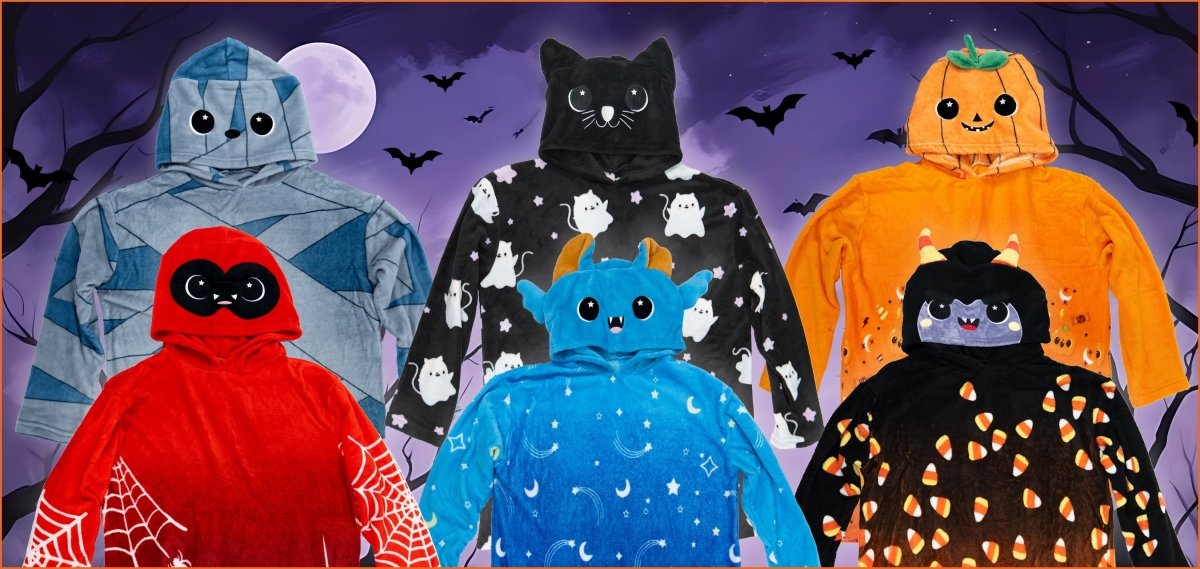 Six Halloween-themed hooded blankets with cute animal faces and designs, set against a spooky night sky with bats, trees, and a full moon in the background.
