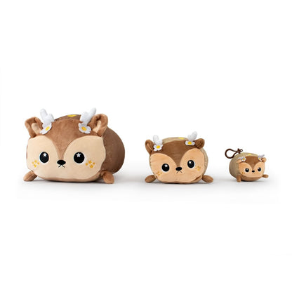 Three charming Chewmoca the Doe Plushies in varying sizes are displayed. They feature light brown fur, white antlers, adorable faces, and tiny flowers on their heads. The plushies range from large to small, each with a round and friendly look.