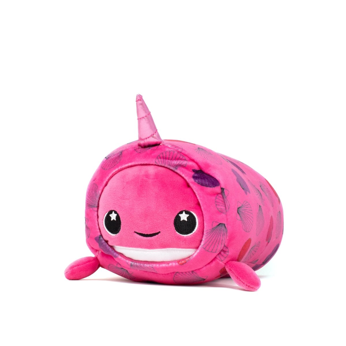 The Bubblegum Slumber Plushie is an adorable narwhal with a round design, starry eyes, a smiling face, and a pink body with seashell patterns and small horns. Featuring soft side fins, it's as squishy as a pillow and machine washable for easy care.