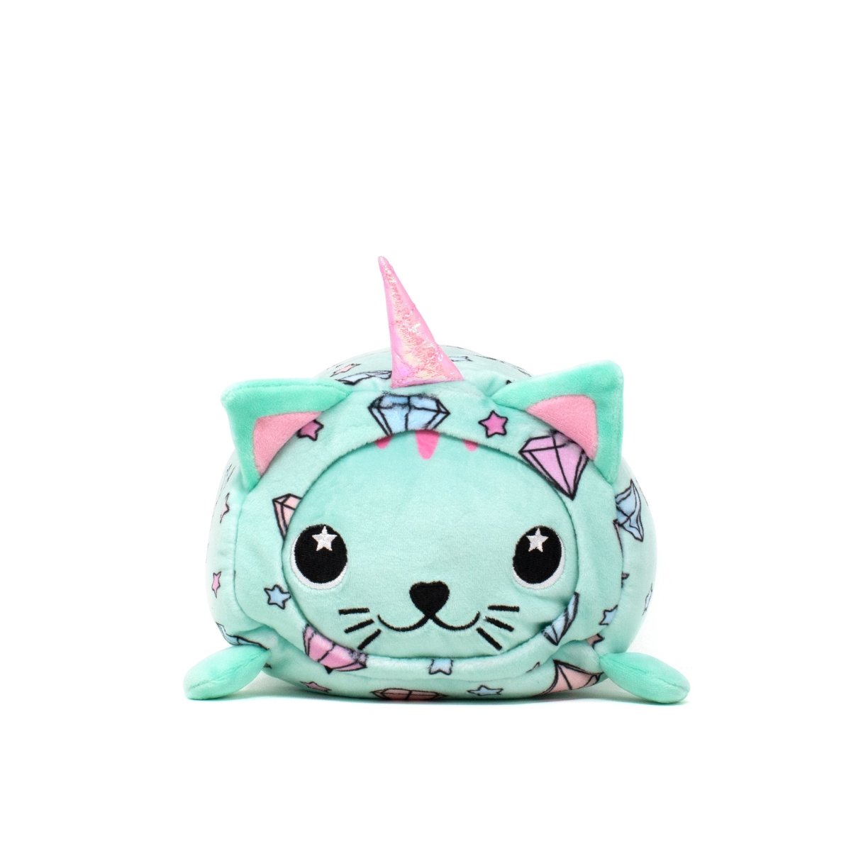 The Blossom - Slumber Plushie is a soft plushie shaped like a cat with a unicorn horn, featuring light teal fabric adorned with pastel gems and stars. It has a cute, smiling face with large starry eyes and tiny pink ears.