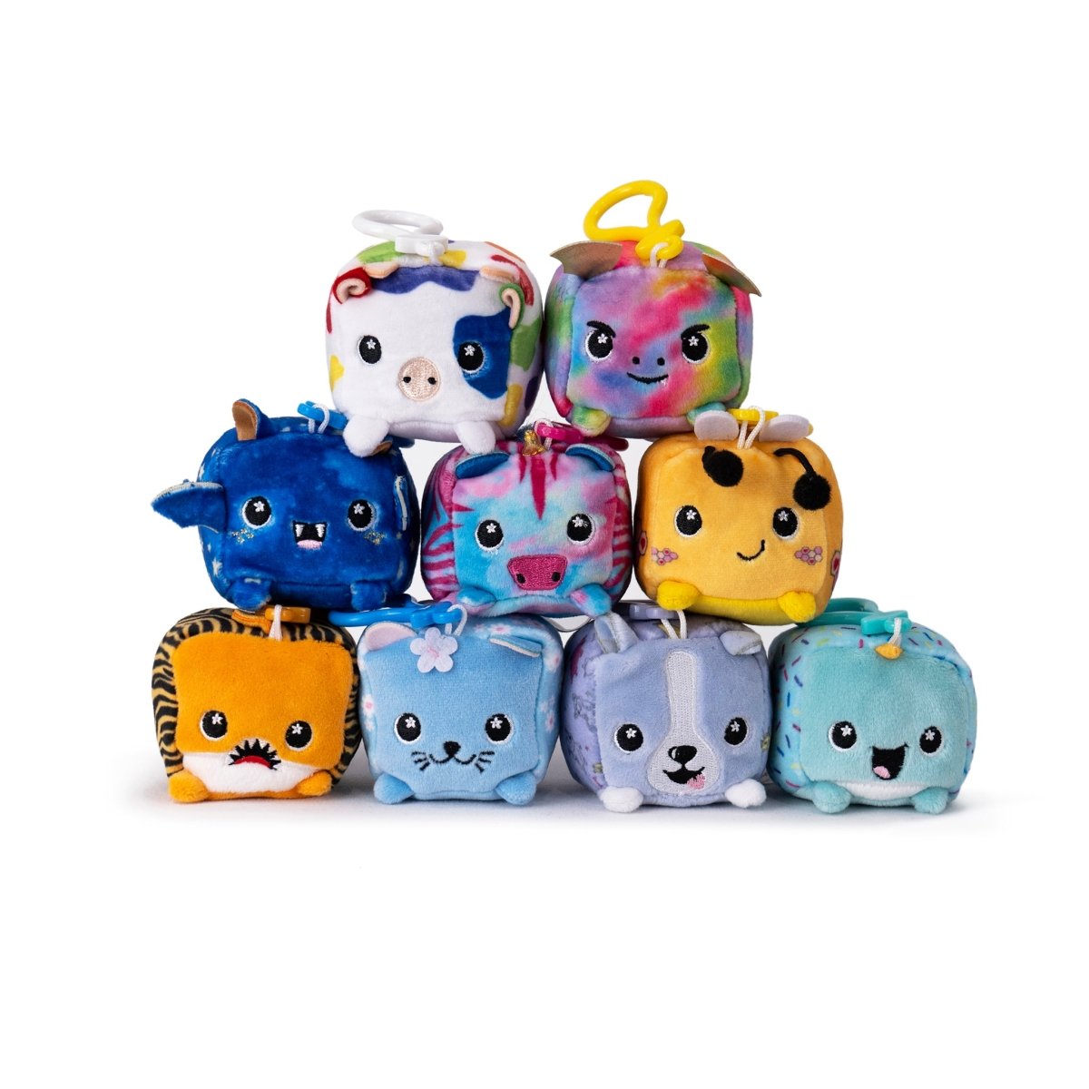 The Moosh-Moosh Series 1 features ten colorful cube-shaped plush toys with animal faces. Among them is Poindexter the Narwhal, part of a lineup that includes unicorns, cows, and tigers, all with small ears and cheerful expressions.