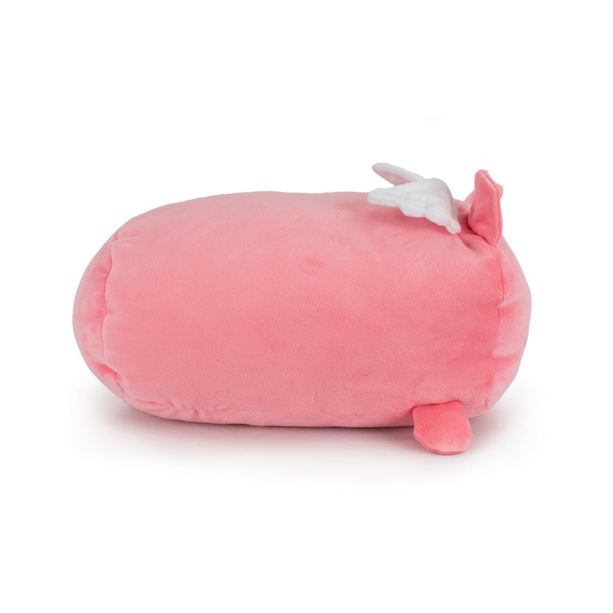 Barnaby the Flying Pig is a soft, pink, oval plush toy featuring a small pink tail, two white wings, and a pink ear or fin on top, shown lying on a white background.