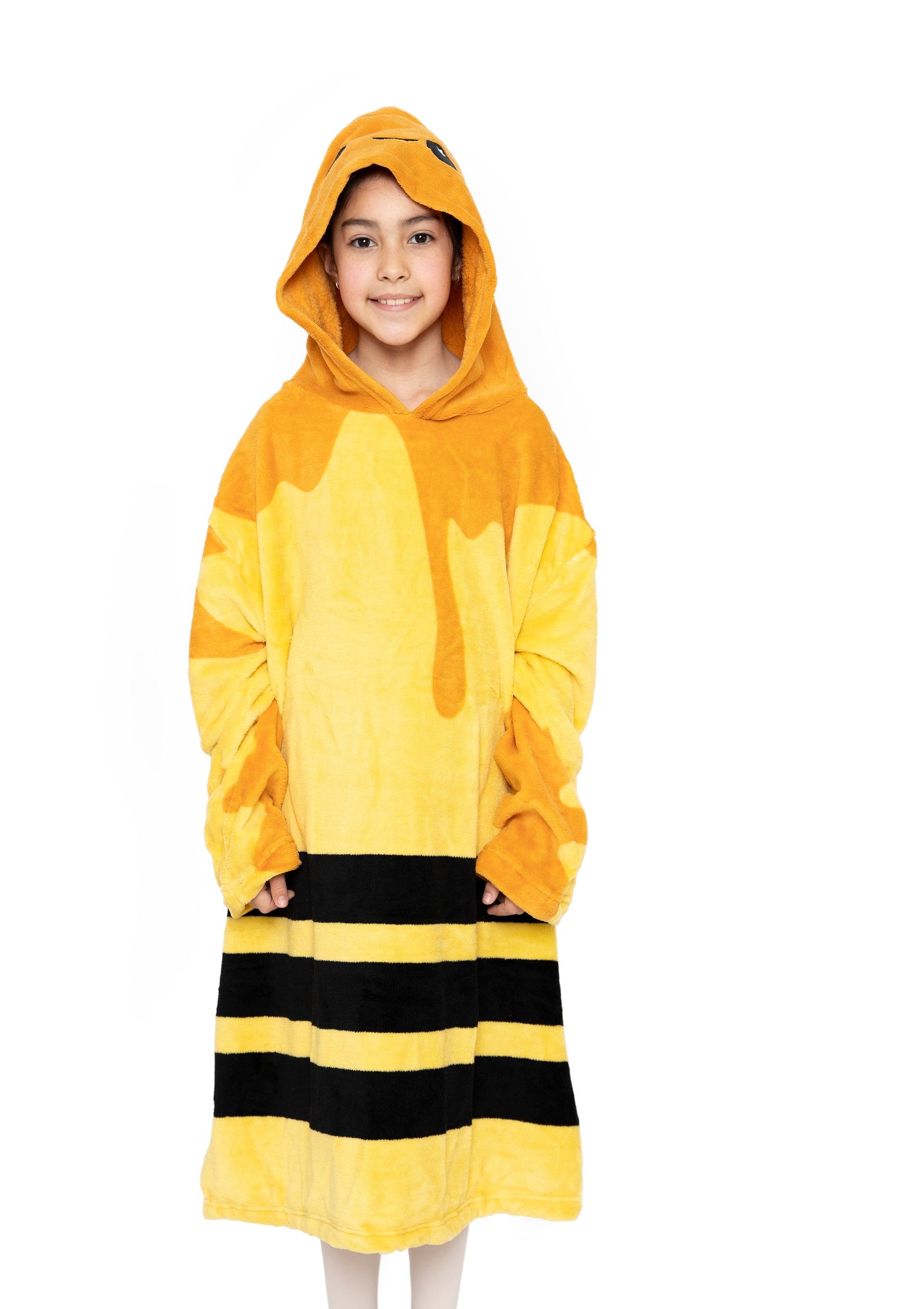 A child smiles while wearing the Hooded Blanket - Vee the Bee, featuring yellow and black stripes with a honey drip design, resembling a bee costume, against a white background.