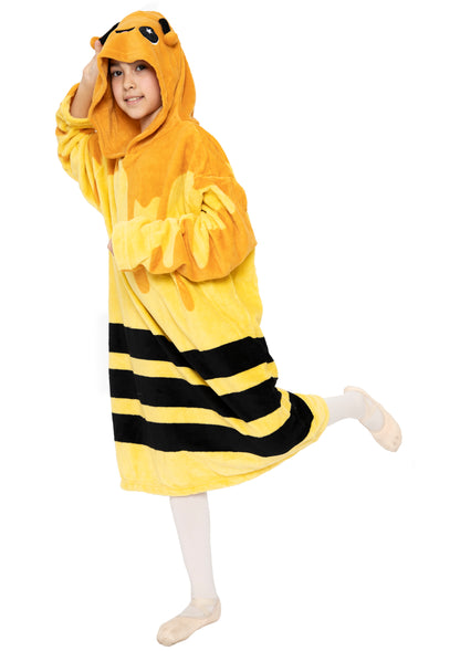 A child playfully poses on one foot against a white background in the Hooded Blanket - Vee the Bee, featuring a cozy design with antennae and eyes on the hood.