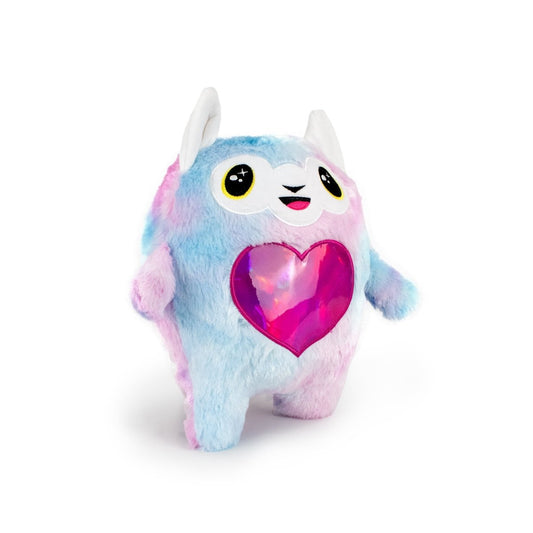 Meet the Llama Bestie Monstah: a soft, cuddly plushie shaped like a colorful round creature with blue, pink, and purple fur, big sparkling eyes, large white ears, and a shiny heart-shaped chest patch—one of the cutest stuffed toys!.