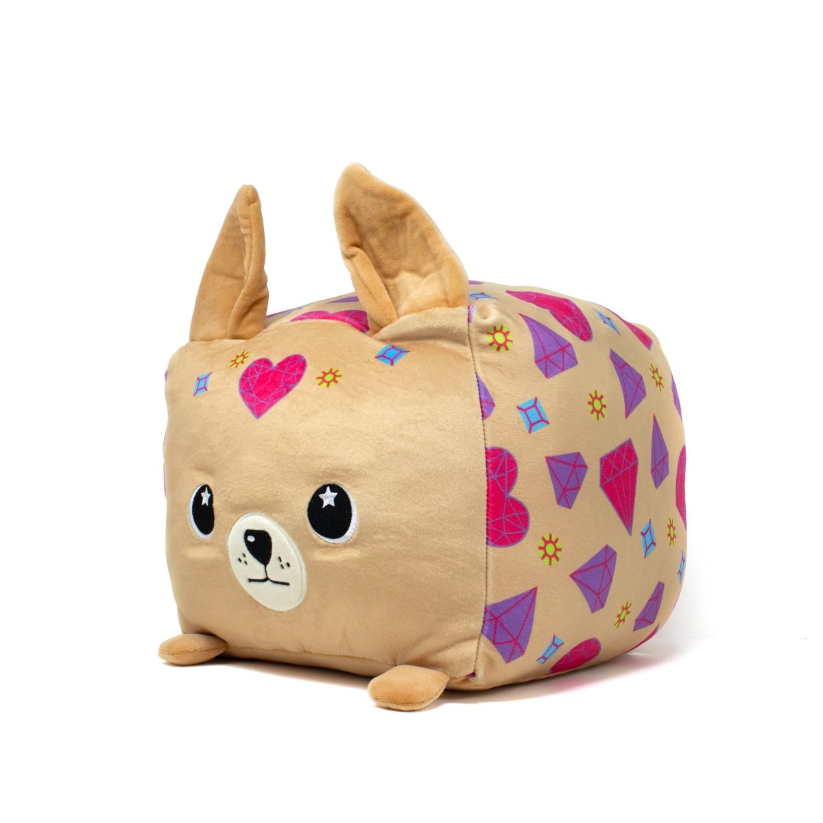 Bev the Chihuahua Plushie is a square, tan toy featuring large floppy ears, big round eyes, and an adorable dog face with a small snout. A heart graces its forehead while pink and purple geometric shapes embellish the sides, enhancing its charm.