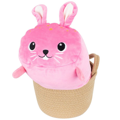 Celeste the Bunny Plushie is an adorable plush bunny with large ears, a smiling face, and whiskers. It features sensory softness in pink with star accents and is nestled inside an Easter basket.