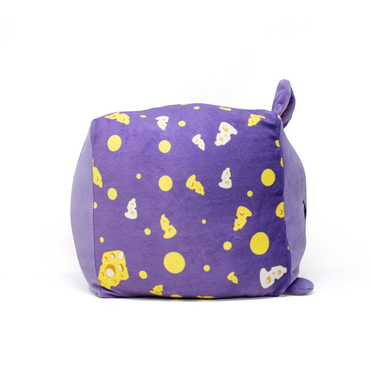 Cheddar the Mouse Plushie is a charming purple cube-shaped stuffed animal with small ears and an adorable face. Its sides feature a pattern of yellow circles and cheese slices, making it a delightful addition to any room.