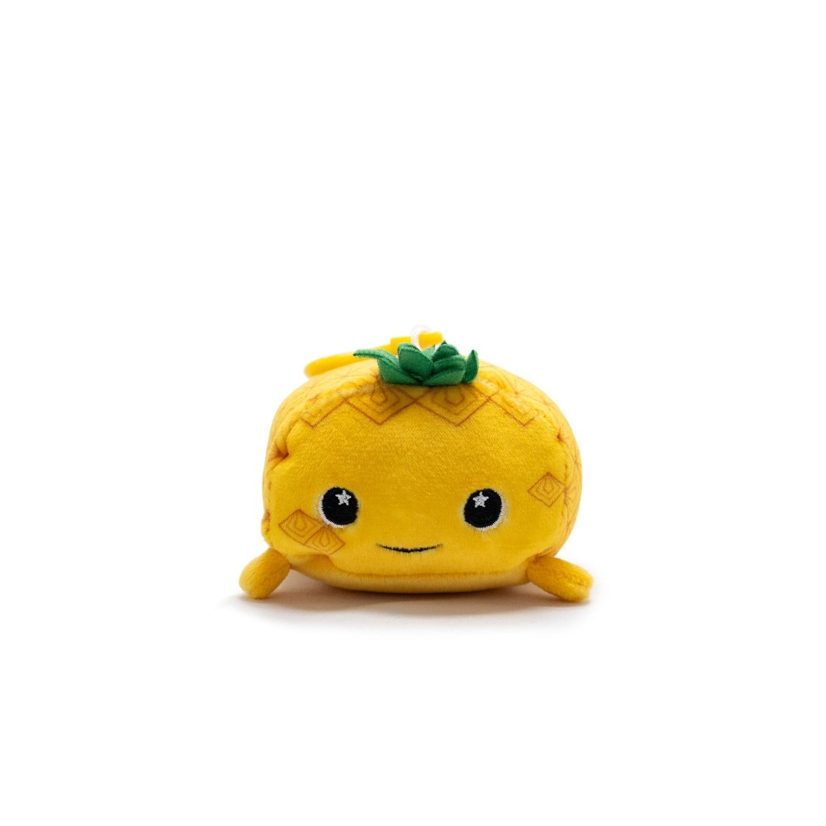 Meet Ana the Pineapple Plush Clip-On! This cute travel buddy features a smiling face, starry eyes, small limbs, and vibrant green leaves. Its compact size makes it the perfect Moosh-Moosh Series companion for all your adventures.