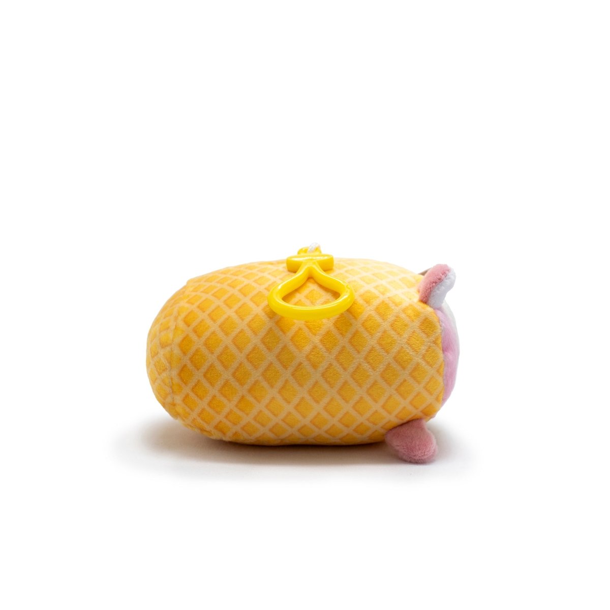 Napoleon the Ice Cream Plush Clip-On, part of Moosh-Moosh Series 5, features a yellow grid-patterned body. It is shown lying on its side against a white background with small pink feet and a pink face, adorned with yellow heart-shaped decorations on its back.