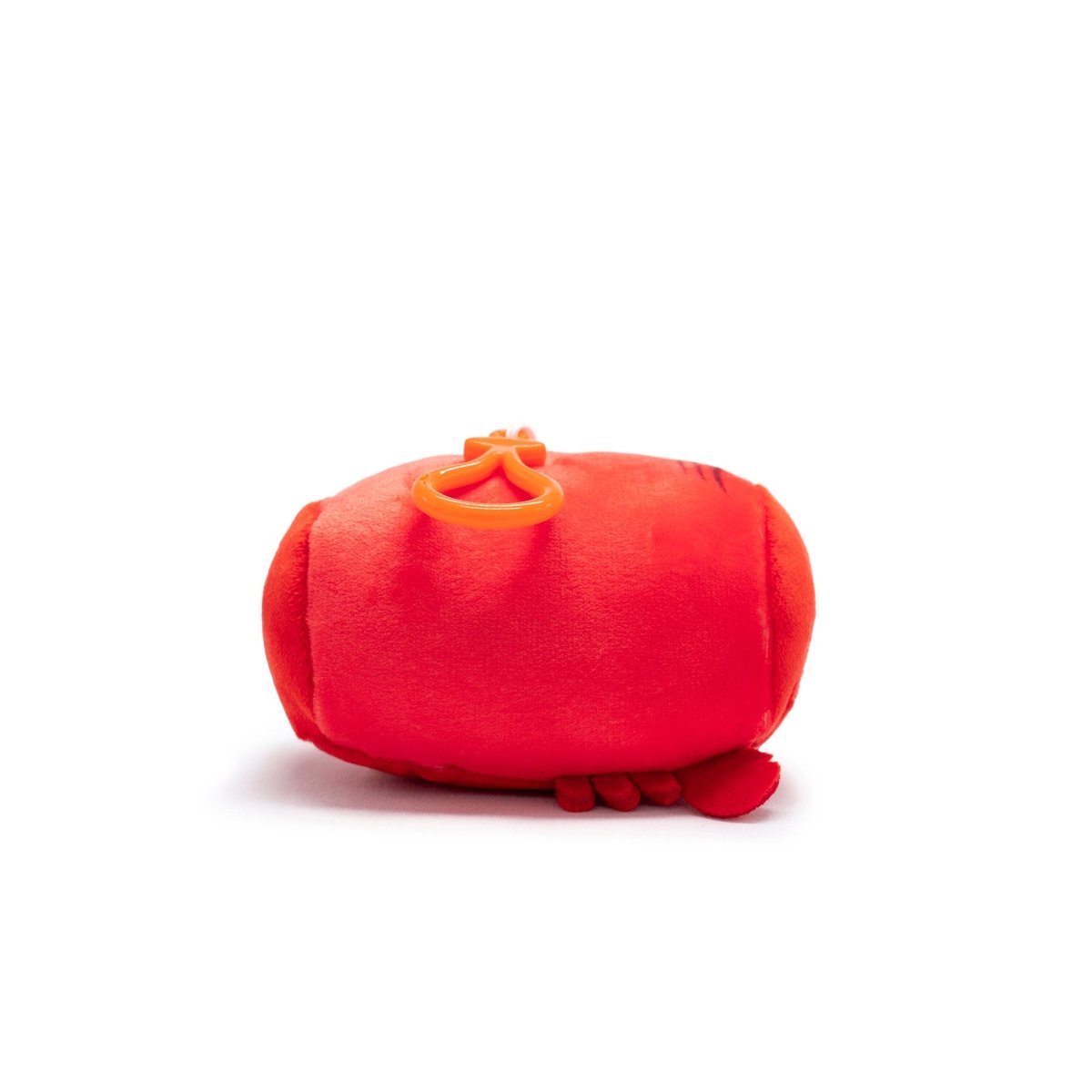 A small, round, red Sebbie the Crab Plush Clip-On is seen on a white background. Featuring little claws and a soft texture, this Moosh-Moosh Series toy has two small eyes on top.