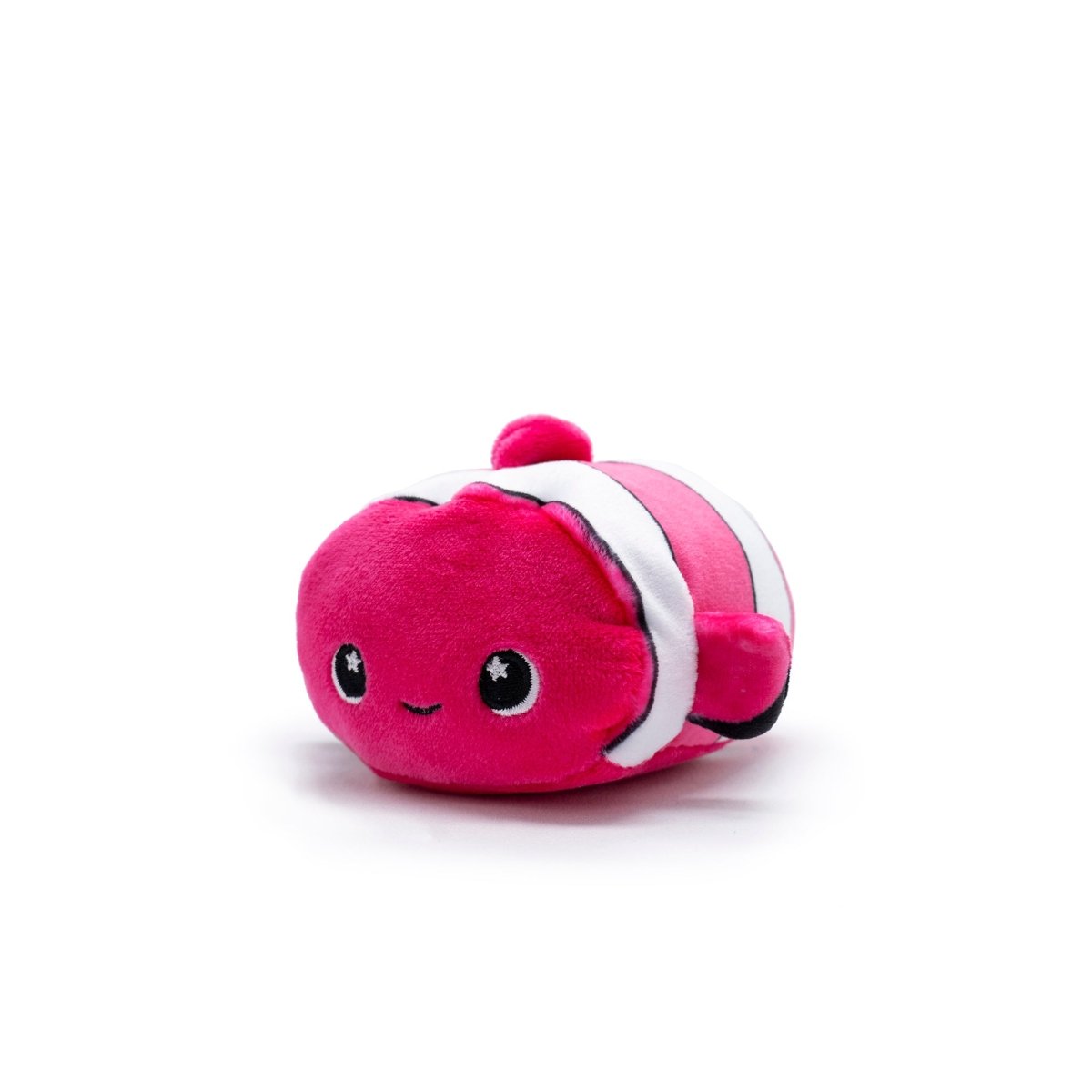 Skipper the Clownfish Plush Clip-On is a small, pink Moosh-Moosh Series 5 toy resembling a fish with a bean shape. It features a smiling face, starry eyes, and is adorned with white and black stripes, all set against a plain white background.