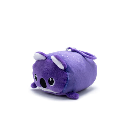 Taz the Koala Plush Clip-On is a small, purple koala toy with large eyes and tiny limbs. Part of the Moosh-Moosh Series 5, it features a round body and simple facial features on a white background, perfect for portable cuteness.