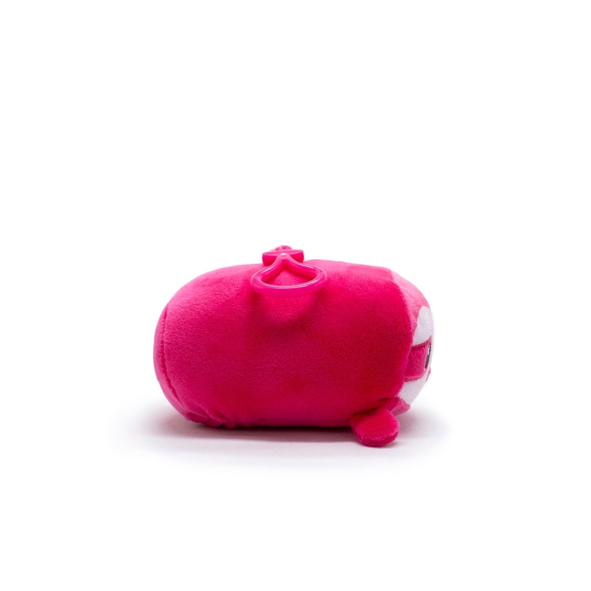 Turbo the Sloth from Moosh-Moosh Series 5, a bright pink bean-shaped stuffed toy with small round feet and eyes, lies on its side against a plain white background.