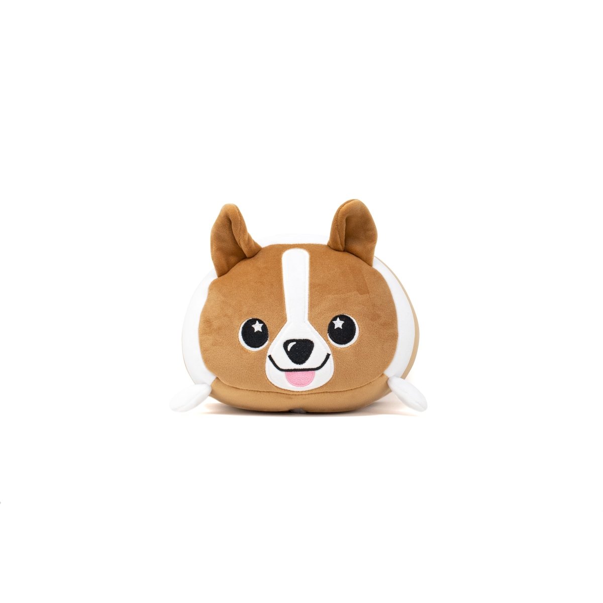 Corey the Puppy 2-In-1 Travel Pillow is a cute plushie with a round body, big eyes featuring star patterns, a pink tongue, brown and white fur, floppy ears, and small paws; it lies gracefully on a white surface.