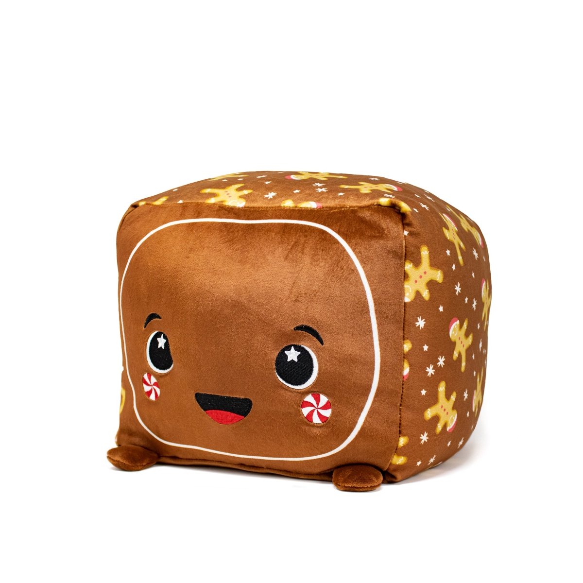 The Crumbles Plushie is a charming brown cube featuring a smiling face, starry eyes, and red cheeks with peppermint swirls. Adorned with yellow gingerbread men and stars, this adorable plush toy is ideal for cuddling.