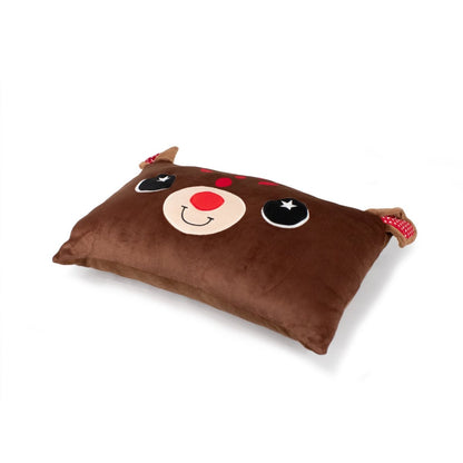 The Renolf the Reindeer Pillow is a cute, brown rectangular pillow featuring a reindeer face with big black eyes, a red nose, and a smiling mouth. It has soft antler-like protrusions at the top corners adorned with red and white checkered fabric details.