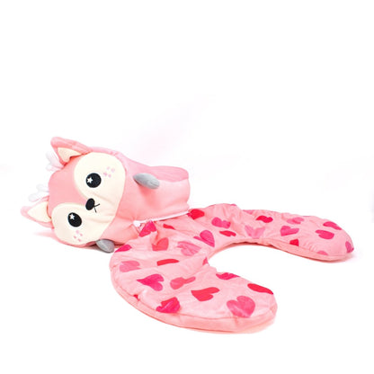 A plush, deer-shaped neck pillow called Doe the Deer 2-In-1 Travel Pillow features a soft pink color with closed eyes, ears, small arms, and heart patterns in pink and red on a white background.