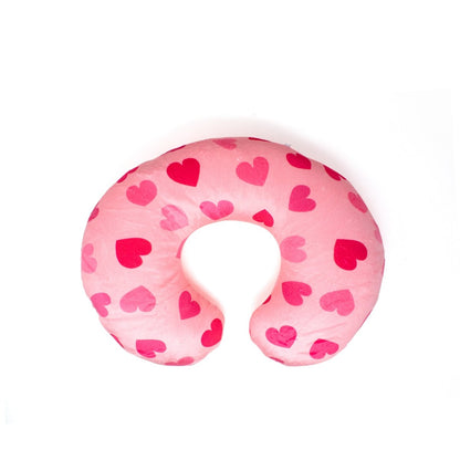 The Doe the Deer 2-In-1 Travel Pillow, a plush U-shaped neck pillow, features pink fabric adorned with heart patterns and offers ultimate comfort for long journeys.