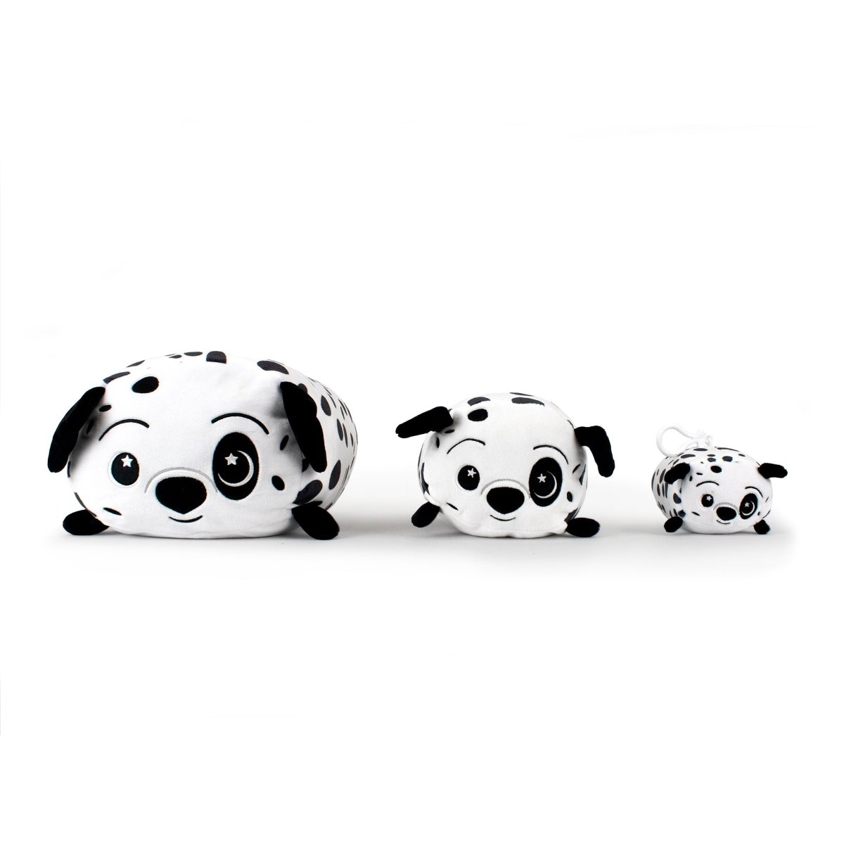 In the Moosh-Moosh Series 5 line-up, three plush Dalmatian toys with black spots, floppy ears, and starry embroidered eyes sit together: the largest on the left, medium in the middle, and Dozer the Dalmatian Plush Clip-On keychain adorably smallest on the right.