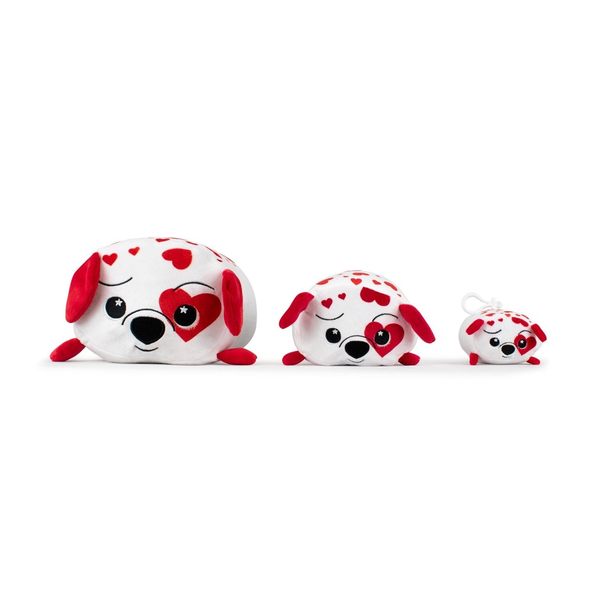 Ed the Dalmatian Plushie set includes three ultra-soft toys in different sizes, each with white and red heart patterns. Ideal for Valentine's cuddles, they feature black button eyes, with the largest toy playfully winking and the smallest equipped with a clip for easy portability.