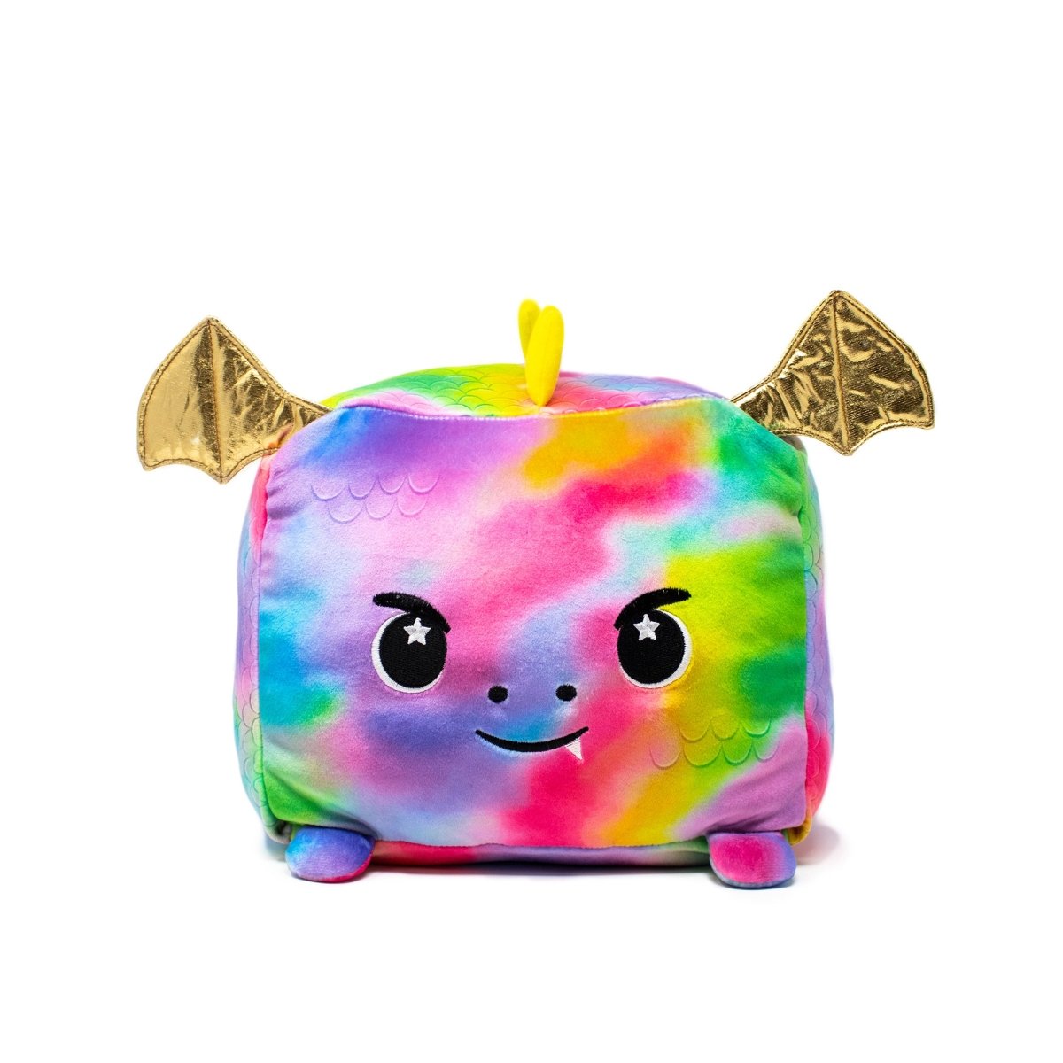 The Emery the Dragon Plushie is a cute, colorful square-shaped plush with a rainbow tie-dye pattern, shiny gold bat-like wings, a small tail, starry eyes on a smiling face, and soft blue feet.