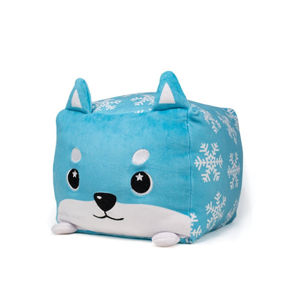 Frost Plushie is a cube-shaped holiday pillow, featuring a cute blue shiba inu with big eyes, pointy ears, and white snowflake patterns on its sides.