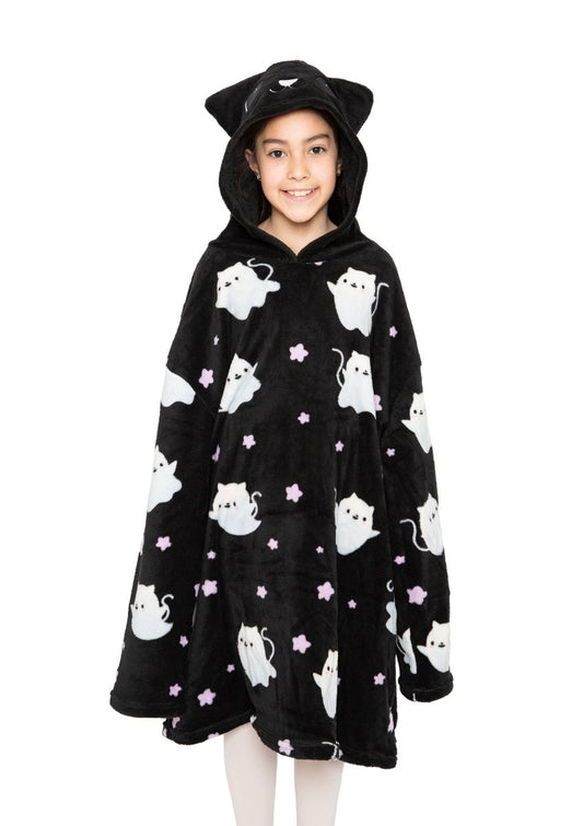 A smiling child wears the Fortune the Cat Hooded Blanket, a black fleece hooded blanket with white cat and pink star prints, plus a hood featuring cat ears and an embroidered face. The background is plain white.